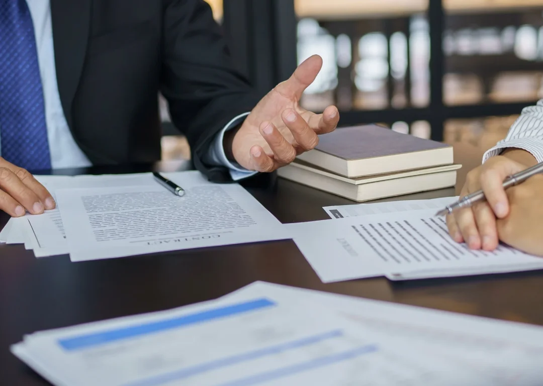 Two people in formal attire in negotiation.