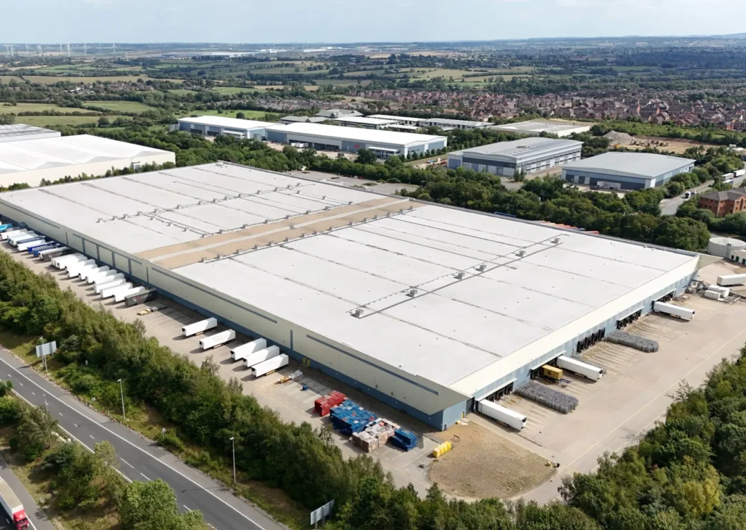 A large industrial site with vehicles pulling in,
